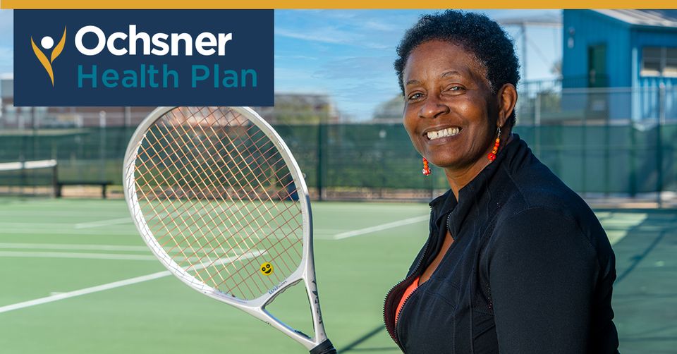 A Woman Holding A Tennis Racket On A Tennis Court.
