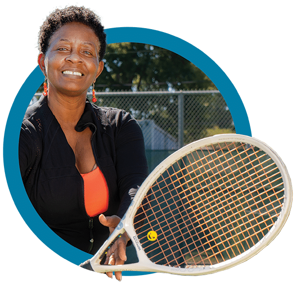 Member Photo In Circle 1 A woman holding a tennis racket and a tennis ball.