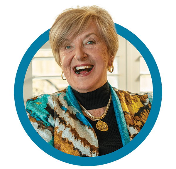 Member Photo In Circle 4 An older woman smiling in a blue circle.