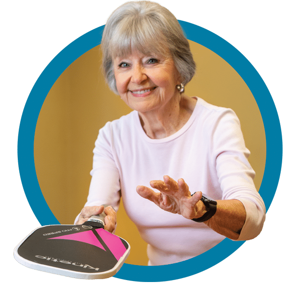 Member Photo In Circle 7 A woman is holding a pink and black frisbee.